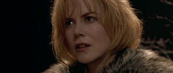 Movie still from “Dogville” (2003), directed by Lars von Trier – A person wearing a fur coat; Close Up shot, Over the shoulder angle