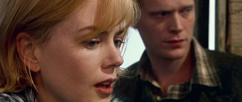 Movie still from “Dogville” (2003), directed by Lars von Trier – A woman's face and a man's face; Close Up shot, Over the shoulder angle