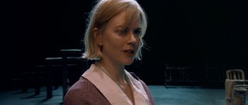 Movie still from “Dogville” (2003), directed by Lars von Trier – A woman with blonde hair wearing a white shirt; Close Up shot, Over the shoulder angle