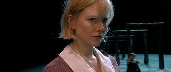 Movie still from “Dogville” (2003), directed by Lars von Trier – A person with blonde hair; Close Up shot, Over the shoulder angle