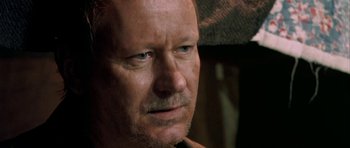 Movie still from “Dogville” (2003), directed by Lars von Trier – A person looking at the camera; Close Up shot, Over the shoulder angle
