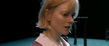 Movie still from “Dogville” (2003), directed by Lars von Trier – A person with blonde hair; Close Up shot, Over the shoulder angle