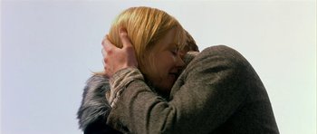 Movie still from “Dogville” (2003), directed by Lars von Trier – Two people hugging each other in the air; Close Up shot, Low angle