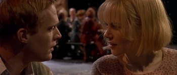 Movie still from “Dogville” (2003), directed by Lars von Trier – A man and a woman talking to each other; Close Up shot, Over the shoulder angle
