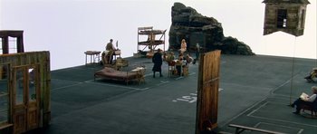 Movie still from “Dogville” (2003), directed by Lars von Trier – A group of people standing on top of a building; Extreme Wide shot, High angle