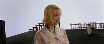 Movie still from “Dogville” (2003), directed by Lars von Trier – A woman with blonde hair wearing a pink shirt; Close Up shot, Over the shoulder angle