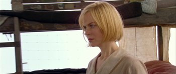 Movie still from “Dogville” (2003), directed by Lars von Trier – A woman with blonde hair is looking to her left; Close Up shot, Over the shoulder angle