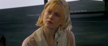 Movie still from “Dogville” (2003), directed by Lars von Trier – A person wearing a head scarf; Close Up shot, Over the shoulder angle