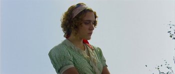 Movie still from “Dogville” (2003), directed by Lars von Trier – A woman with curly blonde hair wearing a green dress; Close Up shot, Low angle