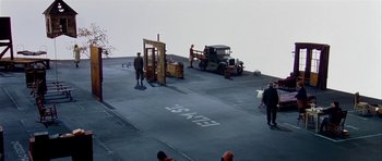 Movie still from “Dogville” (2003), directed by Lars von Trier – A group of men standing on top of a boat; Extreme Wide shot, High angle