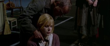 Movie still from “Dogville” (2003), directed by Lars von Trier – A man touching the shoulder of a young woman; Close Up shot, Over the shoulder angle