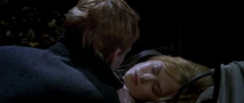Movie still from “Dogville” (2003), directed by Lars von Trier – A man and a woman sleeping on top of each other in the dark; Close Up shot, High angle