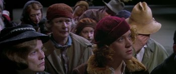 Movie still from “Dogville” (2003), directed by Lars von Trier – A group of people wearing hats in a room; Close Up shot, High angle