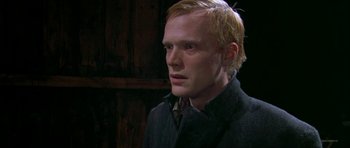 Movie still from “Dogville” (2003), directed by Lars von Trier – A person with blond hair; Close Up shot, Over the shoulder angle