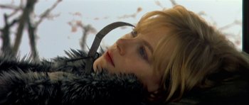Movie still from “Dogville” (2003), directed by Lars von Trier – A person wearing a fur coat; Close Up shot, Low angle