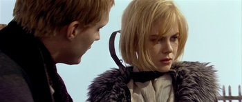 Movie still from “Dogville” (2003), directed by Lars von Trier – A man and a woman standing next to each other; Close Up shot, Over the shoulder angle