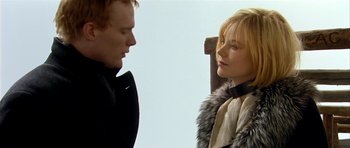 Movie still from “Dogville” (2003), directed by Lars von Trier – A man and a woman standing next to each other; Close Up shot, Over the shoulder angle