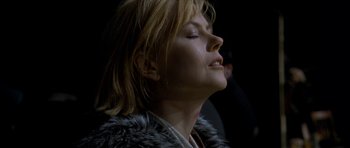 Movie still from “Dogville” (2003), directed by Lars von Trier – A person with her eyes closed; Close Up shot, Low angle