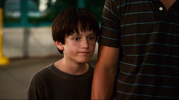 Movie still from “Dolphin Tale” (2011), directed by Charles Martin Smith – A young boy standing next to a person; Close Up shot, Low angle