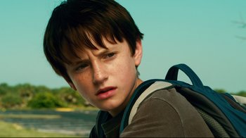 Movie still from “Dolphin Tale” (2011), directed by Charles Martin Smith – A young boy with a backpack looking into the distance; Close Up shot, Low angle