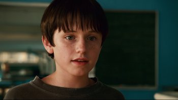 Movie still from “Dolphin Tale” (2011), directed by Charles Martin Smith – A young boy with brown hair and blue eyes; Close Up shot, Low angle