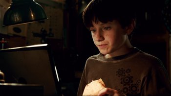 Movie still from “Dolphin Tale” (2011), directed by Charles Martin Smith – A young boy holding a piece of paper in his hand; Close Up shot, Over the shoulder angle