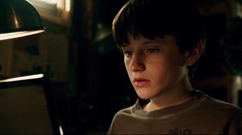 Movie still from “Dolphin Tale” (2011), directed by Charles Martin Smith – A young boy is looking into the camera; Close Up shot, Low angle