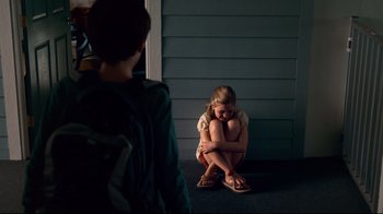 Movie still from “Dolphin Tale” (2011), directed by Charles Martin Smith – A woman sitting on the ground in front of another woman; Wide shot, Over the shoulder angle