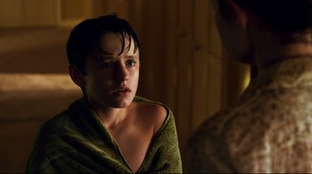 Movie still from “Dolphin Tale” (2011), directed by Charles Martin Smith – A young boy wrapped in a towel in the dark; Close Up shot, Over the shoulder angle