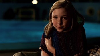 Movie still from “Dolphin Tale” (2011), directed by Charles Martin Smith – A young girl is posing for a picture; Close Up shot, Over the shoulder angle