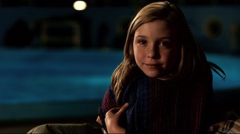 Movie still from “Dolphin Tale” (2011), directed by Charles Martin Smith – A young girl is posing for a picture; Close Up shot, High angle