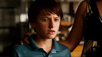 Movie still from “Dolphin Tale” (2011), directed by Charles Martin Smith – A young boy with his arm around a woman's shoulder; Close Up shot, Over the shoulder angle