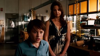 Movie still from “Dolphin Tale” (2011), directed by Charles Martin Smith – A woman and a young boy standing next to each other in a room; Medium shot, Over the shoulder angle