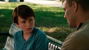 Movie still from “Dolphin Tale” (2011), directed by Charles Martin Smith – Two people sitting on a park bench talking to each other; Close Up shot, Over the shoulder angle