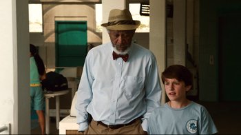 Movie still from “Dolphin Tale” (2011), directed by Charles Martin Smith – An older man and a young boy standing next to each other; Medium shot, Over the shoulder angle