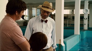 Movie still from “Dolphin Tale” (2011), directed by Charles Martin Smith – An older man wearing a straw hat talking to two women; Medium shot, Over the shoulder angle