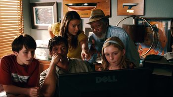 Movie still from “Dolphin Tale” (2011), directed by Charles Martin Smith – A group of people looking at a computer screen; Medium shot, Over the shoulder angle