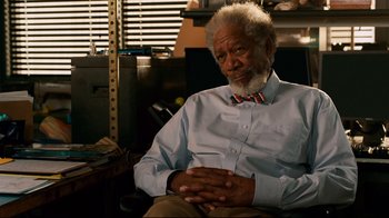 Movie still from “Dolphin Tale” (2011), directed by Charles Martin Smith – An older man sitting in a chair with his hands crossed; Close Up shot, Over the shoulder angle