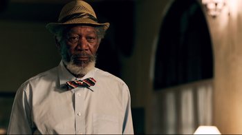Movie still from “Dolphin Tale” (2011), directed by Charles Martin Smith – An older man wearing a hat and a bow tie; Close Up shot, Low angle