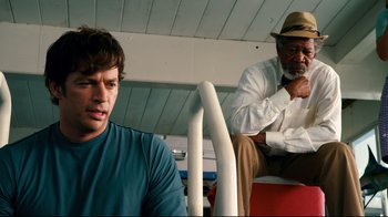 Movie still from “Dolphin Tale” (2011), directed by Charles Martin Smith – A man sitting on a bus next to another man; Medium shot, Low angle
