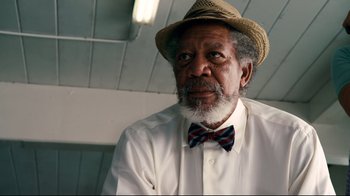Movie still from “Dolphin Tale” (2011), directed by Charles Martin Smith – An older man wearing a hat and a bow tie; Close Up shot, Low angle
