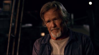 Movie still from “Dolphin Tale” (2011), directed by Charles Martin Smith – An older man with long white hair and a gray beard; Close Up shot, Over the shoulder angle