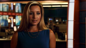 A beautiful blonde woman wearing a blue dress
