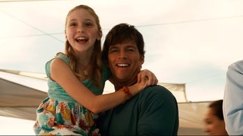 Movie still from “Dolphin Tale” (2011), directed by Charles Martin Smith – A man and a little girl smiling for the camera; Medium shot, Over the shoulder angle