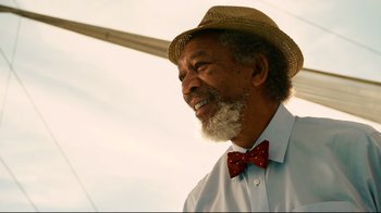 Movie still from “Dolphin Tale” (2011), directed by Charles Martin Smith – An older man wearing a hat and a bow tie; Close Up shot, Low angle