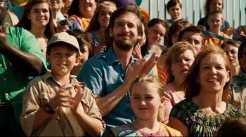 Movie still from “Dolphin Tale” (2011), directed by Charles Martin Smith – A large group of people are gathered in a crowd; Medium shot, Over the shoulder angle