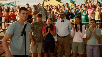 Movie still from “Dolphin Tale” (2011), directed by Charles Martin Smith – A group of people standing next to each other in front of a crowd; Medium shot, Over the shoulder angle
