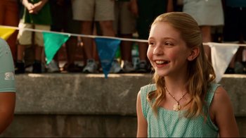 Movie still from “Dolphin Tale” (2011), directed by Charles Martin Smith – A young girl smiles while standing in front of a group of people; Close Up shot, Over the shoulder angle