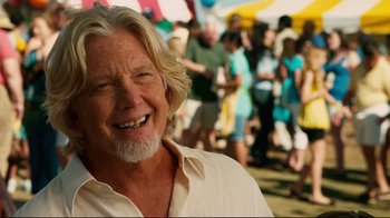 Movie still from “Dolphin Tale” (2011), directed by Charles Martin Smith – An older man with white hair smiling at the camera; Close Up shot, Over the shoulder angle