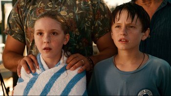 Movie still from “Dolphin Tale” (2011), directed by Charles Martin Smith – A boy and a little girl standing next to each other; Close Up shot, Low angle